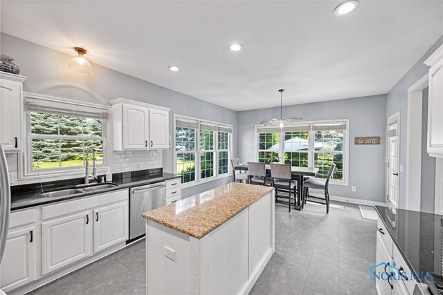 7910 Quail Creek Rd, Maumee, OH 43537 - kitchen featuring stainless steel dishwasher, white cabinets, recessed lighting, backsplash, and dark stone countertops