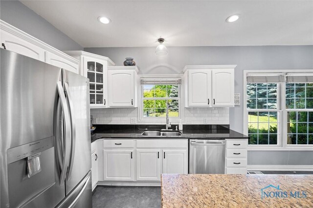 7910 Quail Creek Rd, Maumee, OH 43537 - kitchen featuring stainless steel appliances, white cabinetry, decorative backsplash, glass insert cabinets, and recessed lighting