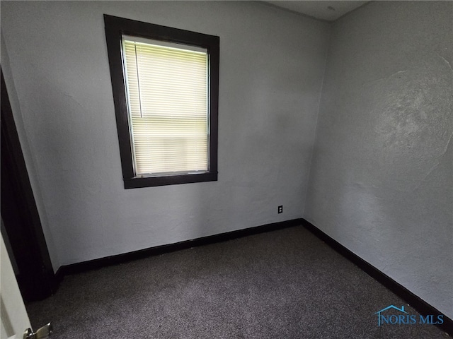 1133 Sherman St, Toledo, OH 43608 - unfurnished room featuring dark colored carpet and baseboards