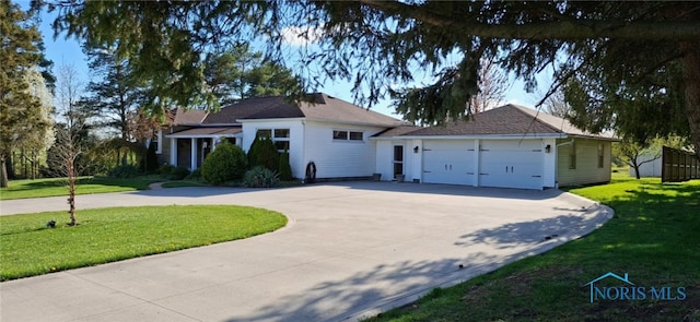 8962 State Route 109, Ottawa, OH 45875 - ranch-style house with curved driveway, a front lawn, and a garage