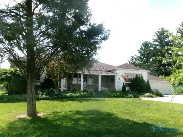 8962 State Route 109, Ottawa, OH 45875 - view of front of property with a front yard, concrete driveway, and a garage
