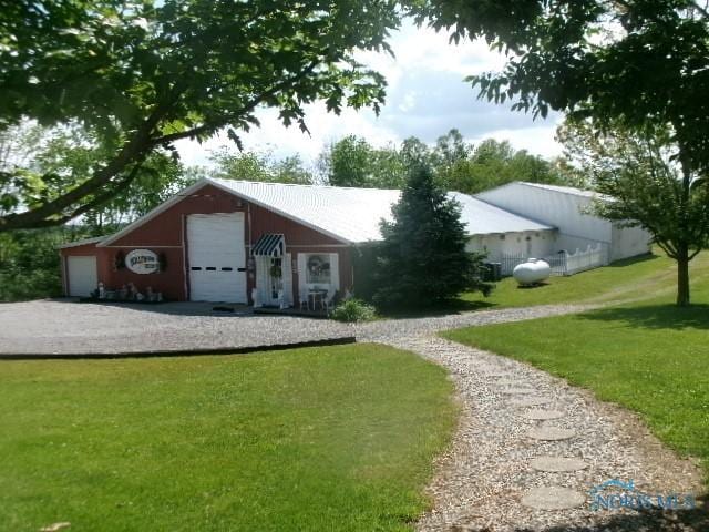 8962 State Route 109, Ottawa, OH 45875 - view of front of house with a front lawn and a detached garage