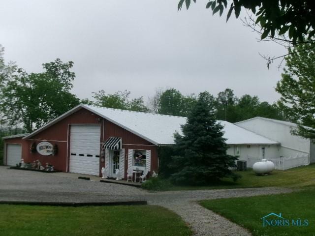 8962 State Route 109, Ottawa, OH 45875 - view of front of house with a front yard and a detached garage