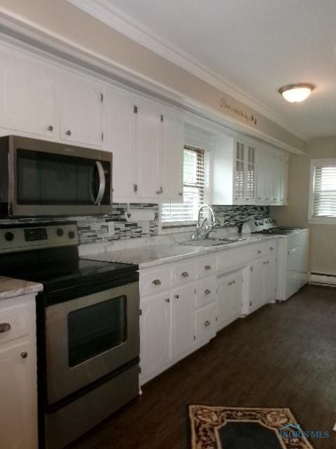 8962 State Route 109, Ottawa, OH 45875 - kitchen featuring stainless steel appliances, white cabinetry, backsplash, dark wood-type flooring, and crown molding
