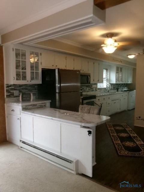8962 State Route 109, Ottawa, OH 45875 - kitchen featuring baseboard heating, stainless steel appliances, tasteful backsplash, and glass insert cabinets