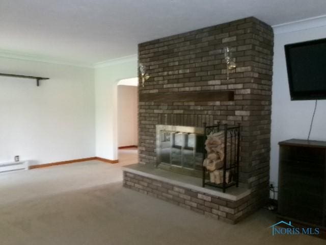 8962 State Route 109, Ottawa, OH 45875 - unfurnished living room featuring ornamental molding, a fireplace, carpet floors, and arched walkways