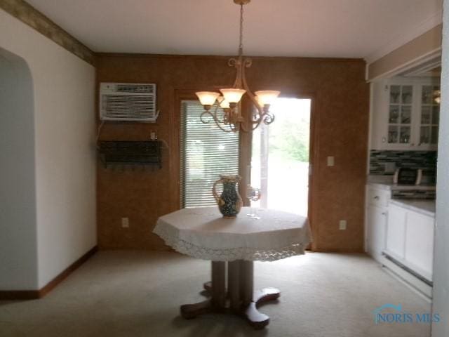 8962 State Route 109, Ottawa, OH 45875 - dining space with a wall mounted AC, a chandelier, light colored carpet, and arched walkways