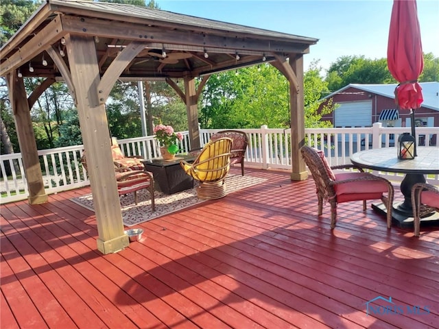 8962 State Route 109, Ottawa, OH 45875 - wooden deck with outdoor dining space, a gazebo, and an outdoor structure