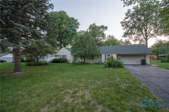 2823 Wicklow Rd, Toledo, OH 43606 - single story home with a garage, asphalt driveway, a front yard, and a chimney