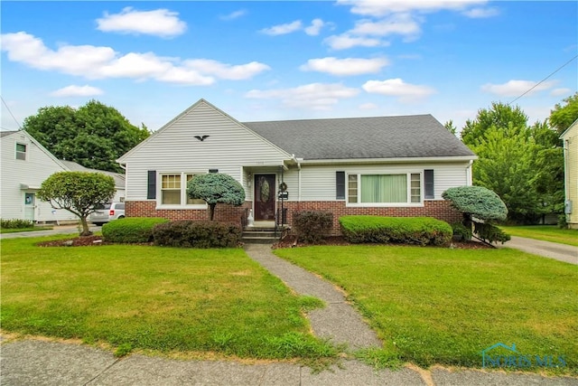 1013 Whittlesey St, Fremont, OH 43420 - view of front facade featuring brick siding, a front yard, and roof with shingles
