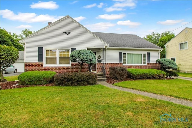 1013 Whittlesey St, Fremont, OH 43420 - bungalow-style home featuring brick siding, a front yard, and roof with shingles