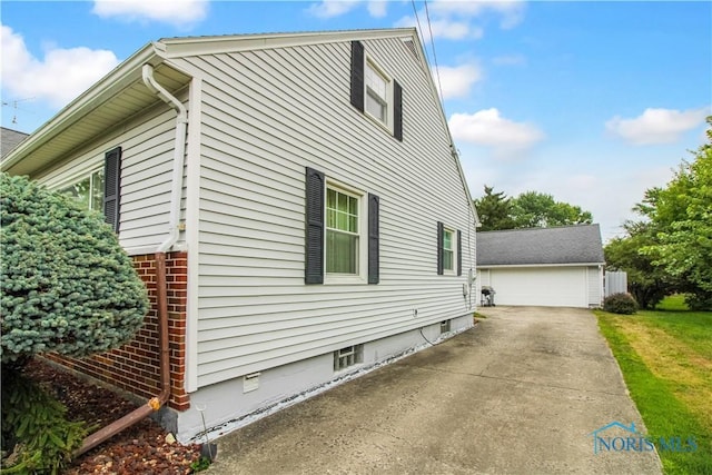 1013 Whittlesey St, Fremont, OH 43420 - view of home's exterior with an outdoor structure and a detached garage
