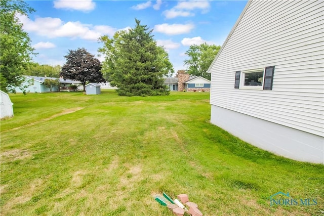 1013 Whittlesey St, Fremont, OH 43420 - view of green lawn featuring a storage unit