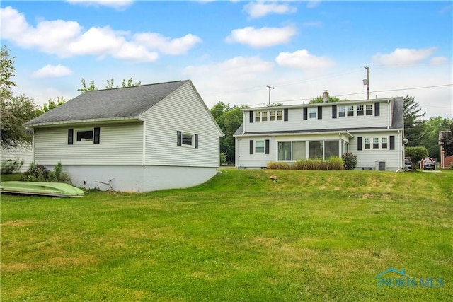 1013 Whittlesey St, Fremont, OH 43420 - rear view of house with a yard and a sunroom