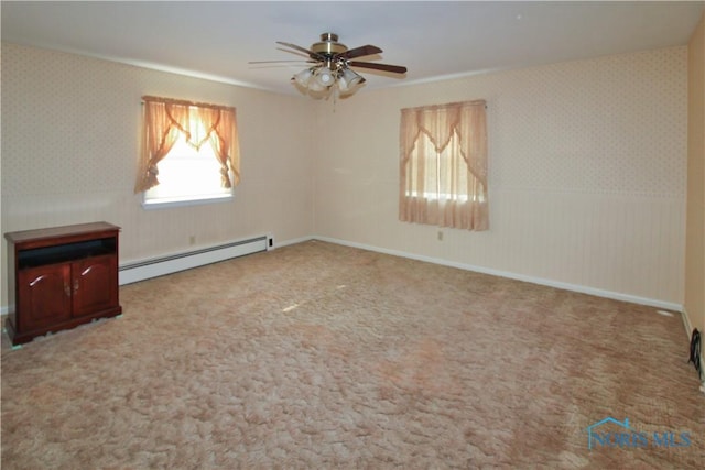 1013 Whittlesey St, Fremont, OH 43420 - carpeted spare room featuring baseboard heating, wallpapered walls, and a ceiling fan