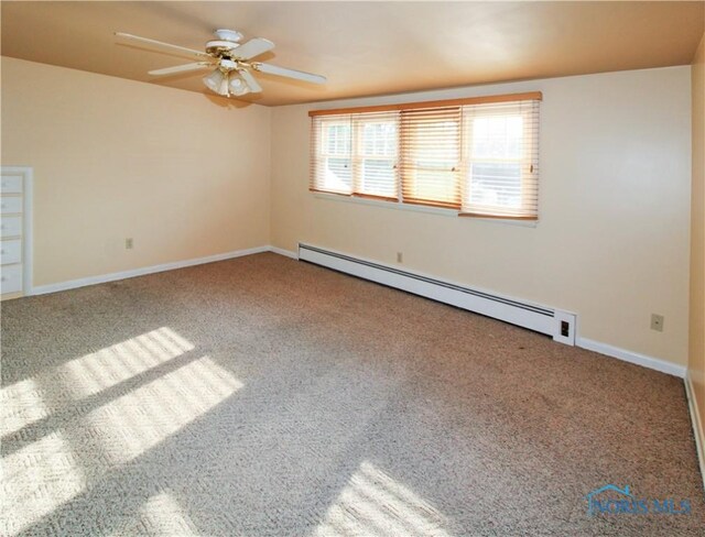 1013 Whittlesey St, Fremont, OH 43420 - carpeted empty room with a baseboard heating unit and ceiling fan