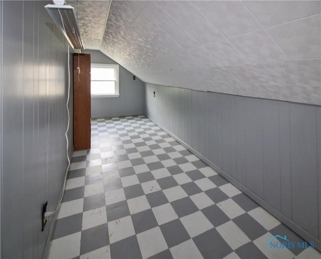1013 Whittlesey St, Fremont, OH 43420 - bonus room featuring tile patterned floors, vaulted ceiling, and wooden walls