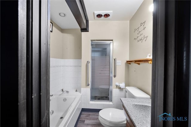 6005 Bahiamar Rd, Toledo, OH 43611 - bathroom featuring a garden tub, wood finished floors, vanity, wainscoting, and tile walls