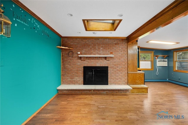 6005 Bahiamar Rd, Toledo, OH 43611 - unfurnished living room with wood finished floors, a wall unit AC, crown molding, a brick fireplace, and a skylight