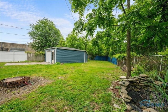 6005 Bahiamar Rd, Toledo, OH 43611 - fenced backyard with a detached garage, driveway, and an outbuilding
