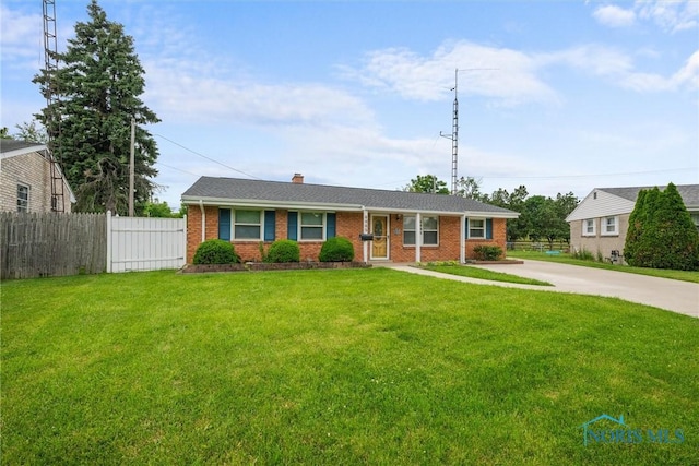 6005 Bahiamar Rd, Toledo, OH 43611 - ranch-style home with brick siding, a chimney, and driveway