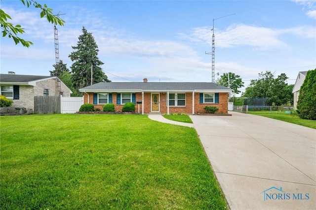 6005 Bahiamar Rd, Toledo, OH 43611 - single story home with concrete driveway, brick siding, and a chimney