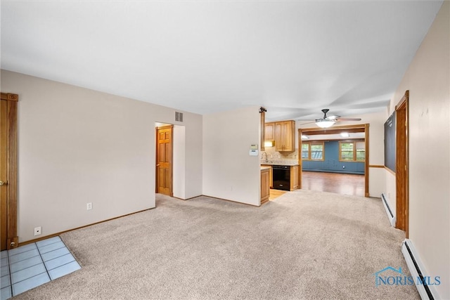 6005 Bahiamar Rd, Toledo, OH 43611 - unfurnished living room with a baseboard heating unit, ceiling fan, and light carpet