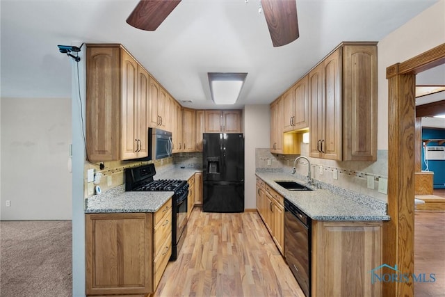 6005 Bahiamar Rd, Toledo, OH 43611 - kitchen with black appliances, a ceiling fan, and light stone counters