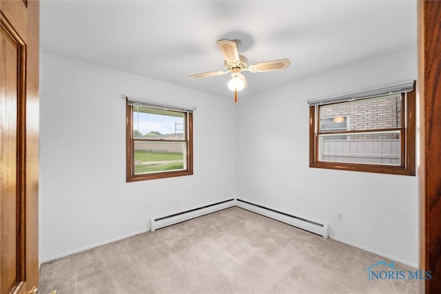 6005 Bahiamar Rd, Toledo, OH 43611 - empty room with light carpet, ceiling fan, and a baseboard radiator