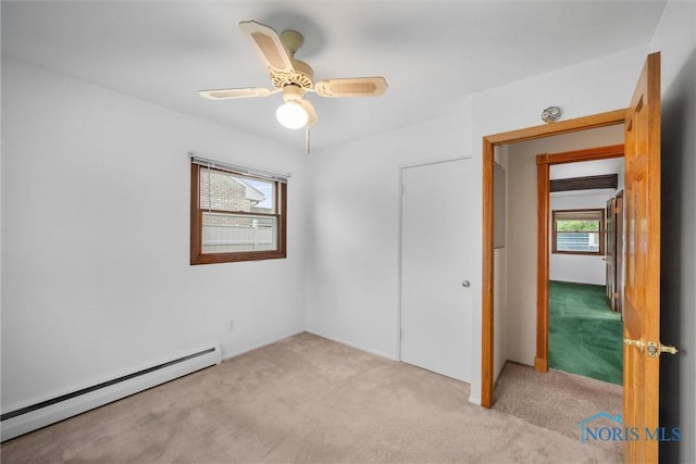 6005 Bahiamar Rd, Toledo, OH 43611 - unfurnished bedroom featuring baseboard heating, light colored carpet, and ceiling fan