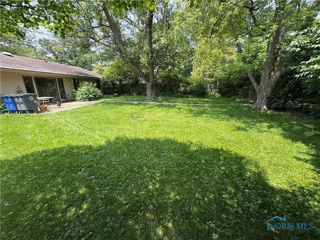 1035 Cherry St, Perrysburg, OH 43551 - view of green lawn featuring a patio