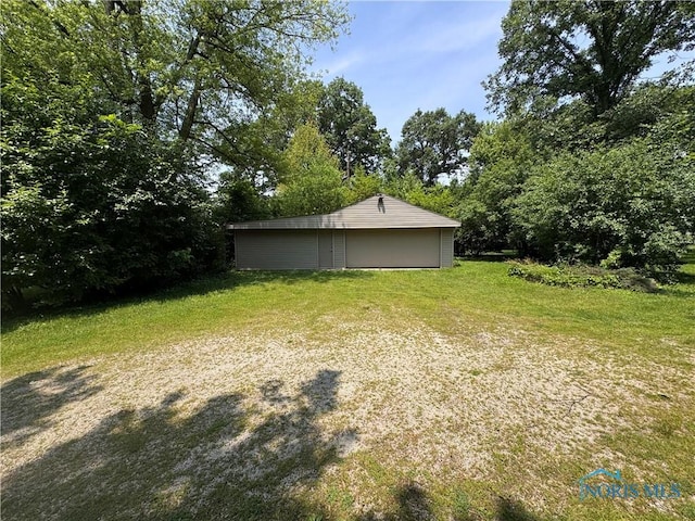 1035 Cherry St, Perrysburg, OH 43551 - view of grassy yard with a garage and an outdoor structure