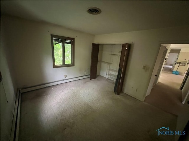 1035 Cherry St, Perrysburg, OH 43551 - unfurnished bedroom featuring a baseboard heating unit and a closet
