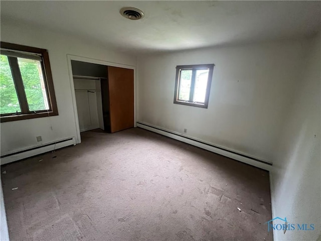1035 Cherry St, Perrysburg, OH 43551 - unfurnished bedroom featuring a baseboard radiator, carpet flooring, and a closet