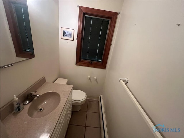 1035 Cherry St, Perrysburg, OH 43551 - bathroom with baseboard heating, tile patterned flooring, and vanity