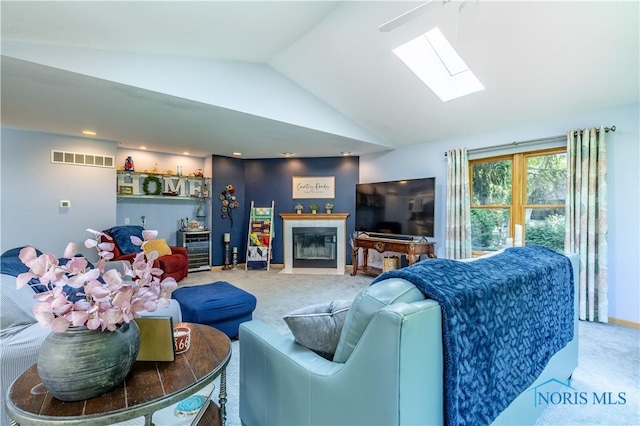5868 Winslow Rd, Whitehouse, OH 43571 - carpeted living area featuring lofted ceiling, a skylight, and a fireplace