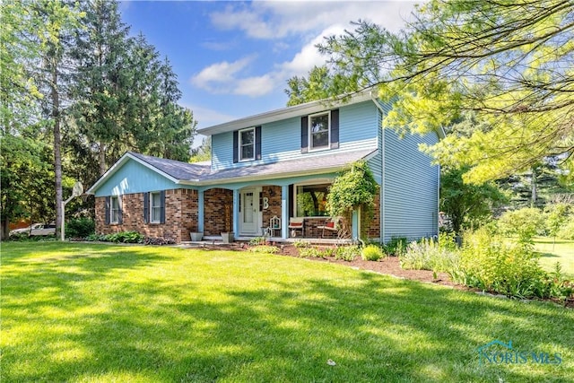 5868 Winslow Rd, Whitehouse, OH 43571 - view of front of property featuring covered porch, brick siding, and a front yard
