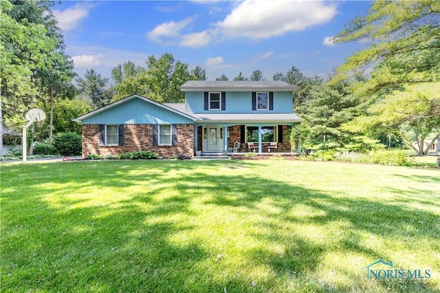 5868 Winslow Rd, Whitehouse, OH 43571 - traditional-style house featuring brick siding, a porch, and a front lawn