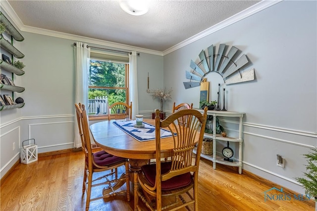 5868 Winslow Rd, Whitehouse, OH 43571 - dining space with ornamental molding, a textured ceiling, and wood finished floors