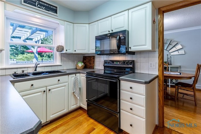 5868 Winslow Rd, Whitehouse, OH 43571 - kitchen featuring black appliances, light wood finished floors, and white cabinets