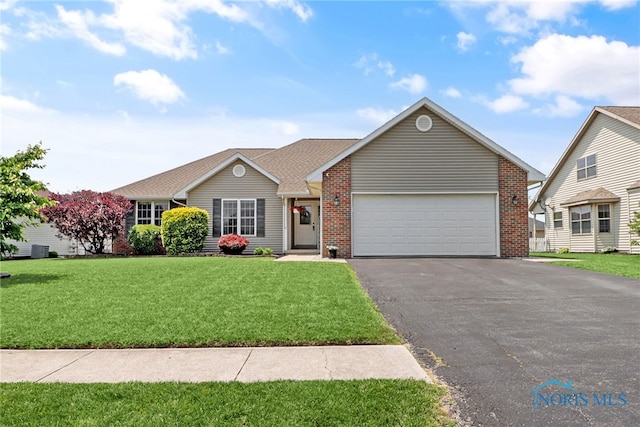 740 Tarra Oaks Dr, Findlay, OH 45840 - ranch-style house featuring a garage, asphalt driveway, brick siding, and a front lawn