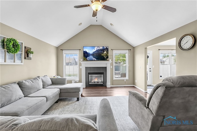 740 Tarra Oaks Dr, Findlay, OH 45840 - living room featuring ceiling fan, dark wood finished floors, vaulted ceiling, and a glass covered fireplace