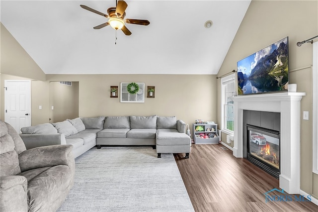 740 Tarra Oaks Dr, Findlay, OH 45840 - living area with lofted ceiling, ceiling fan, wood finished floors, and a tile fireplace