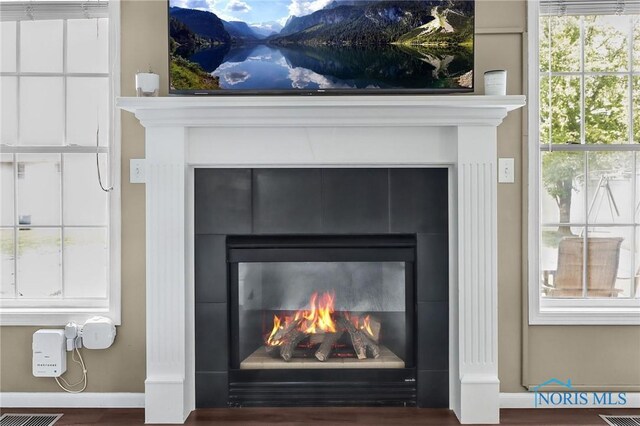 740 Tarra Oaks Dr, Findlay, OH 45840 - detailed view of a tiled fireplace and wood finished floors