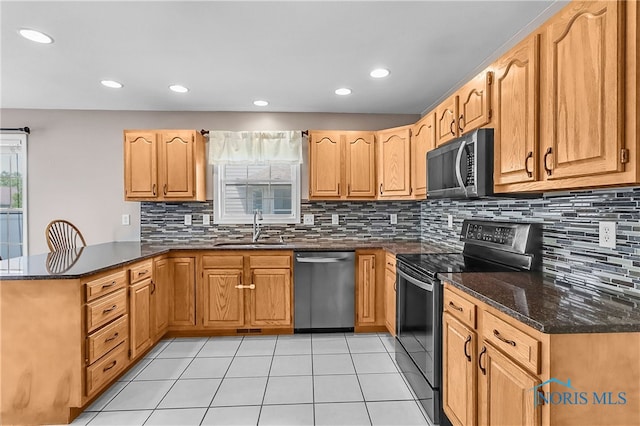 740 Tarra Oaks Dr, Findlay, OH 45840 - kitchen featuring black appliances, a peninsula, decorative backsplash, dark stone countertops, and recessed lighting