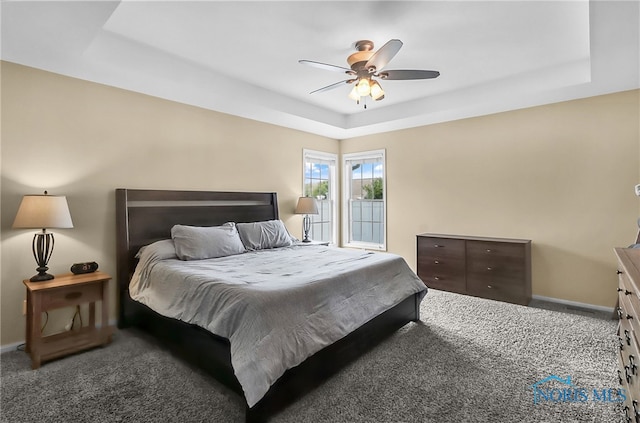 740 Tarra Oaks Dr, Findlay, OH 45840 - carpeted bedroom featuring a tray ceiling and a ceiling fan