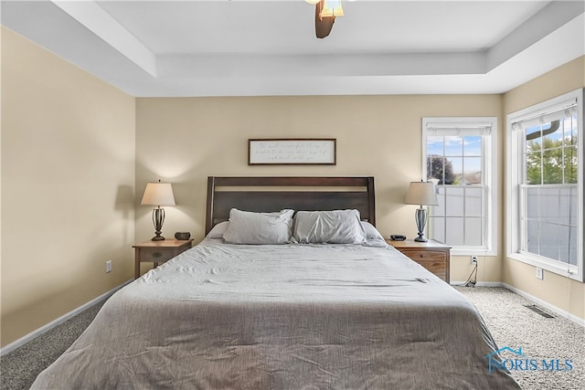 740 Tarra Oaks Dr, Findlay, OH 45840 - bedroom with a tray ceiling, carpet flooring, and a ceiling fan