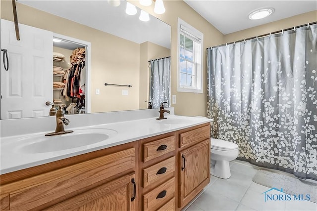 740 Tarra Oaks Dr, Findlay, OH 45840 - bathroom with double vanity, tile patterned floors, a shower with curtain, and a walk in closet