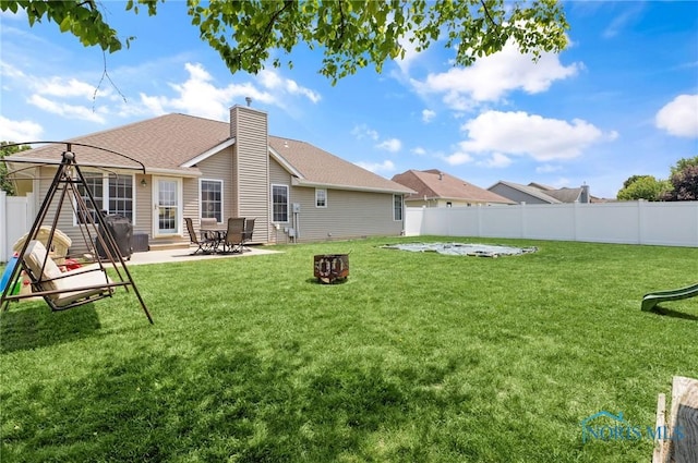 740 Tarra Oaks Dr, Findlay, OH 45840 - rear view of house featuring a fenced backyard, a chimney, a patio area, and a shingled roof