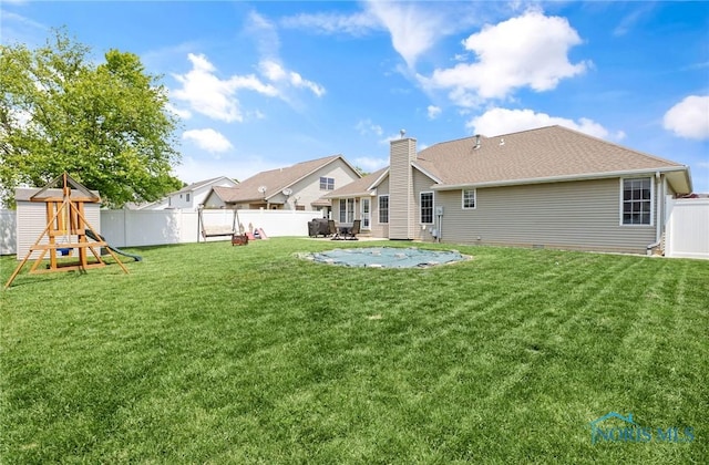 740 Tarra Oaks Dr, Findlay, OH 45840 - back of house with a playground, a fenced backyard, a patio, and roof with shingles